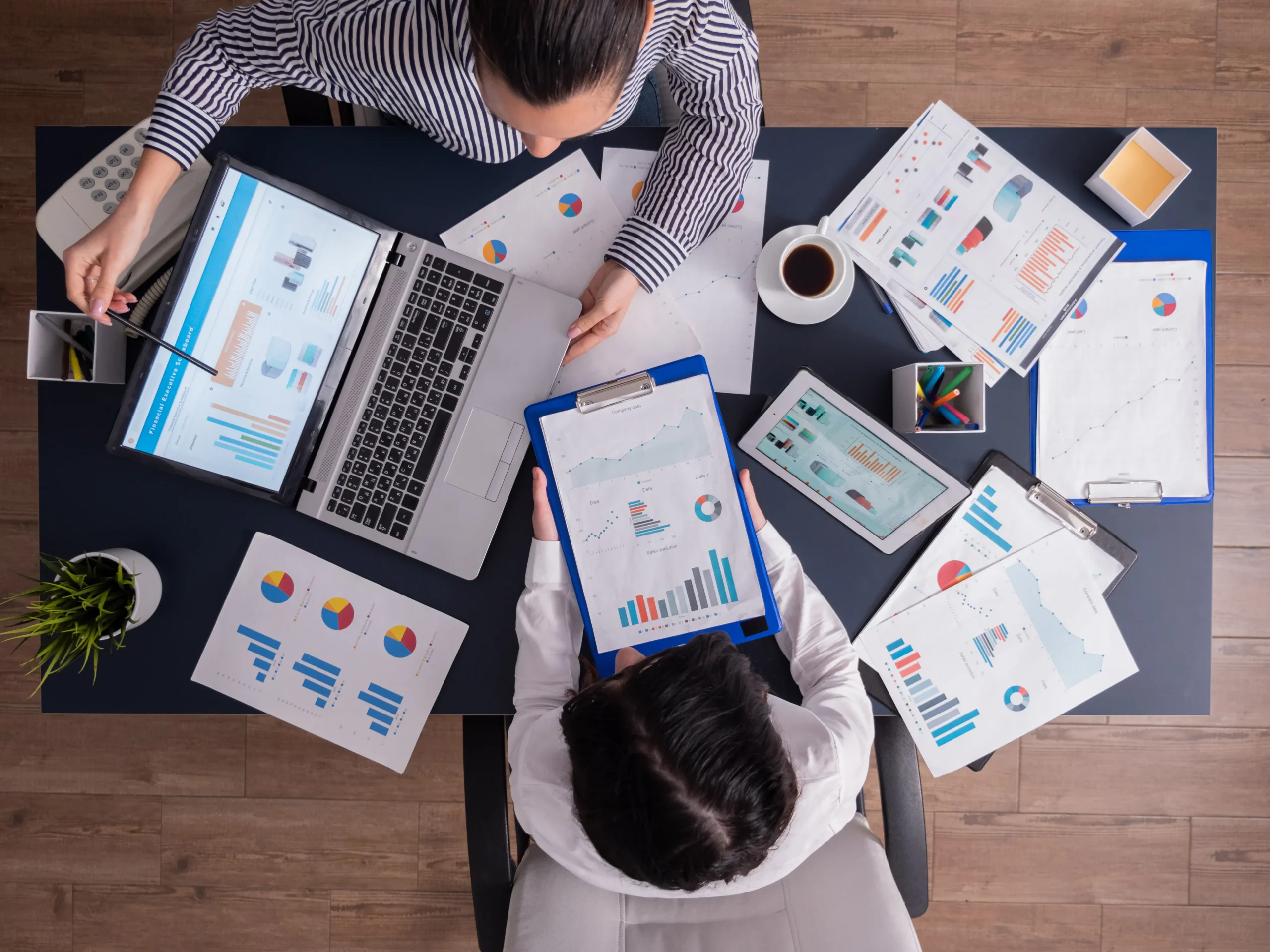 top-viewtop-view-manager-employee-doing-teamwork-business-office-looking-charts-laptop-display-optimized